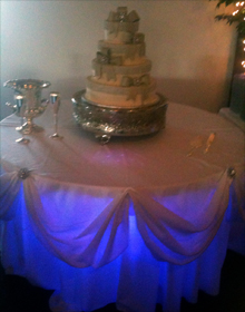Wedding cake table with blue uplighting