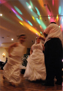 Guests dancing under colored party lights