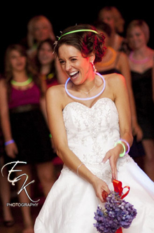 A bride laughing during the bouquet toss