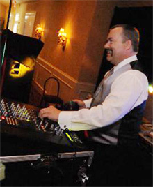 Jeff behind the DJ controls at a reception